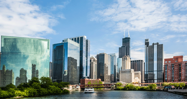 Chicago Illinois office buildings skyline in background with river in foreground