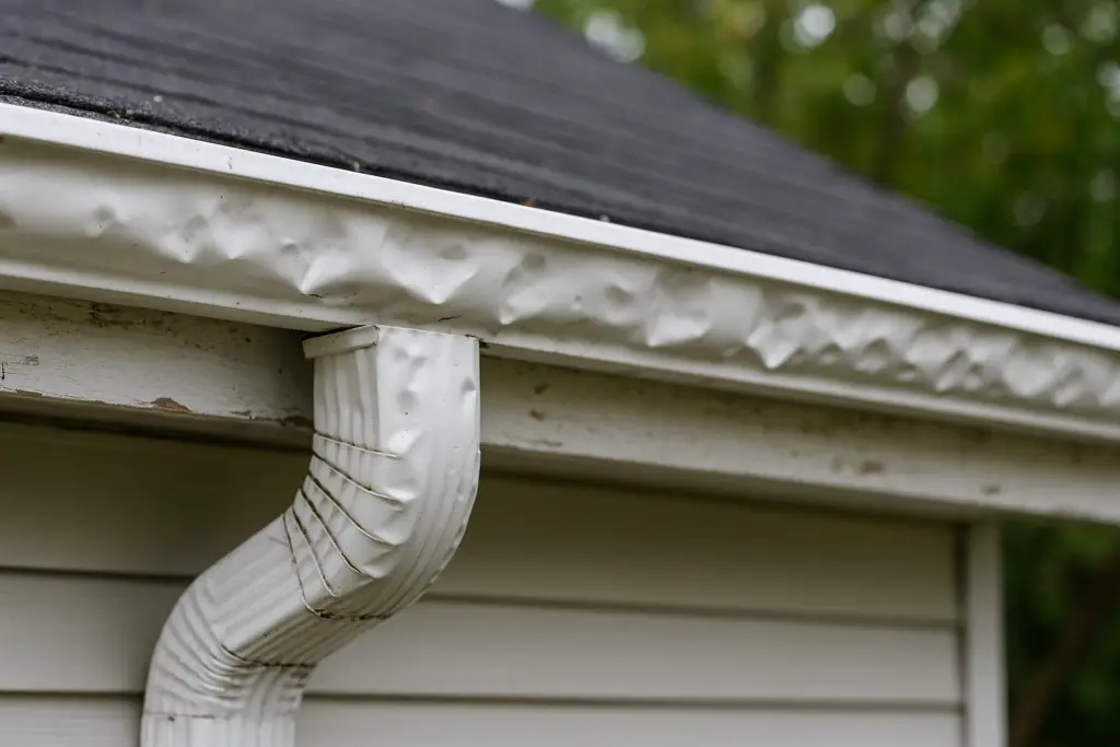 hailed-damaged guttering off of roof