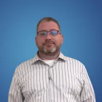 Man with a beard wearing a striped button shirt